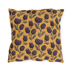 Deep plum artichoke thistles on warm ochre outdoor pillow