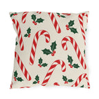 Christmas outdoor pillow with red and white candy canes and holly on cream
