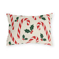 Christmas outdoor lumbar pillow with red and white candy canes and holly on cream