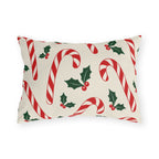 Christmas outdoor lumbar pillow with red and white candy canes and holly on cream
