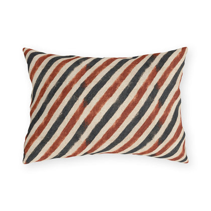 Diagonal rust and charcoal block-printed stripes on cream outdoor lumbar pillow