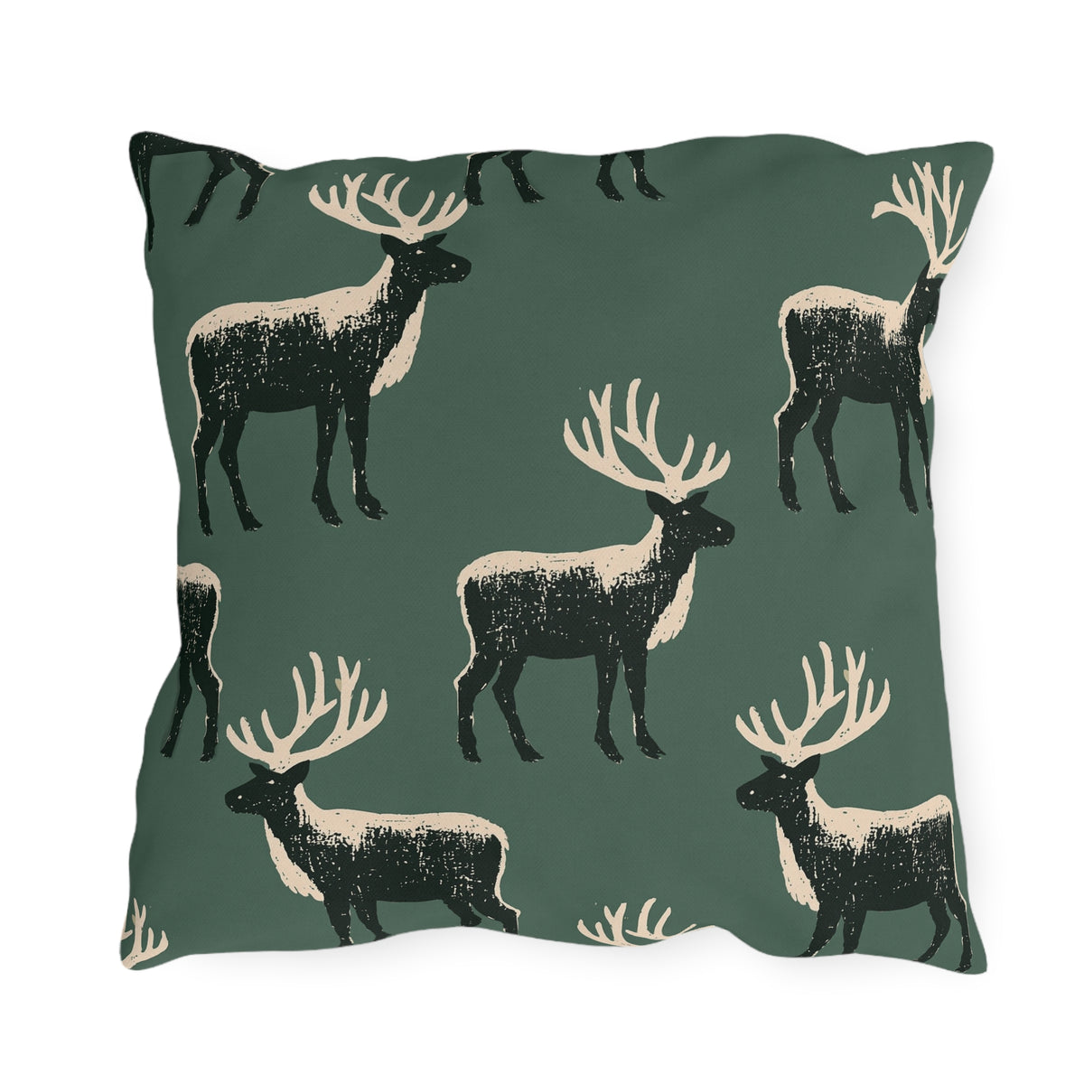 Black and cream block print stags on a deep forest green outdoor pillow