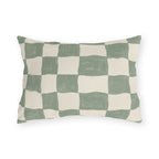 Modern outdoor lumbar pillow with a hand-painted sage green and cream checkerboard