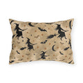 Black witch silhouettes on broomsticks with bats and crescent moons on tan outdoor lumbar pillow