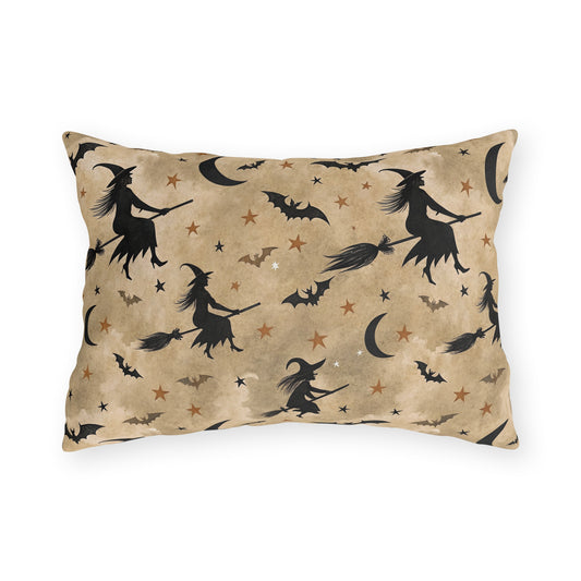 Black witch silhouettes on broomsticks with bats and crescent moons on tan outdoor lumbar pillow