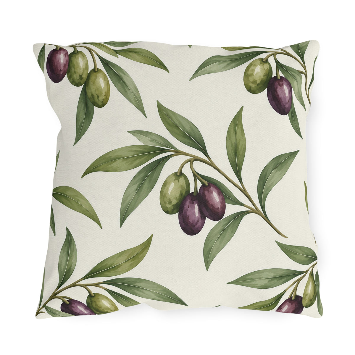Green and purple olives on branches over a cream outdoor pillow