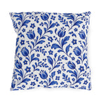 Scattered cobalt blue tulips and vines on a white outdoor pillow