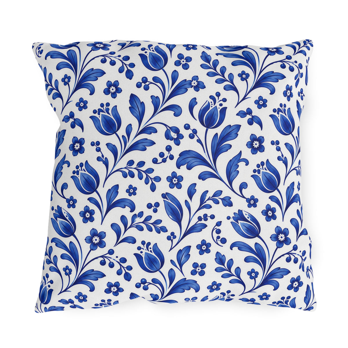 Scattered cobalt blue tulips and vines on a white outdoor pillow