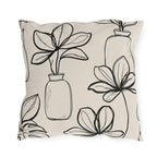 Black line-drawn plants in bottle vases on a cream outdoor pillow