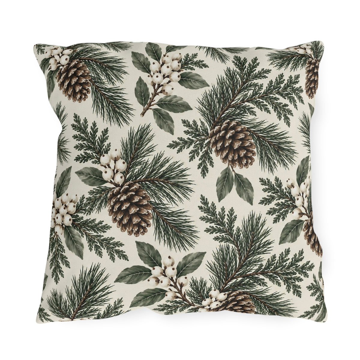 Pine branches, cedar sprigs, pinecones and white berries on a cream outdoor pillow