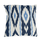 Navy and white ikat stripe outdoor pillow with feathered navy bands and light blue accents