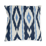 Navy and white ikat stripe outdoor pillow with feathered navy bands and light blue accents