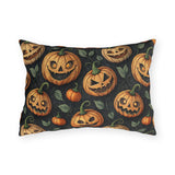 Carved jack-o-lantern pumpkins and vines on charcoal outdoor lumbar pillow