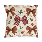 Christmas outdoor pillow with watercolor brown satin bows, red gingham bow, pinecones and holly on cream