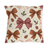Christmas outdoor pillow with watercolor brown satin bows, red gingham bow, pinecones and holly on cream