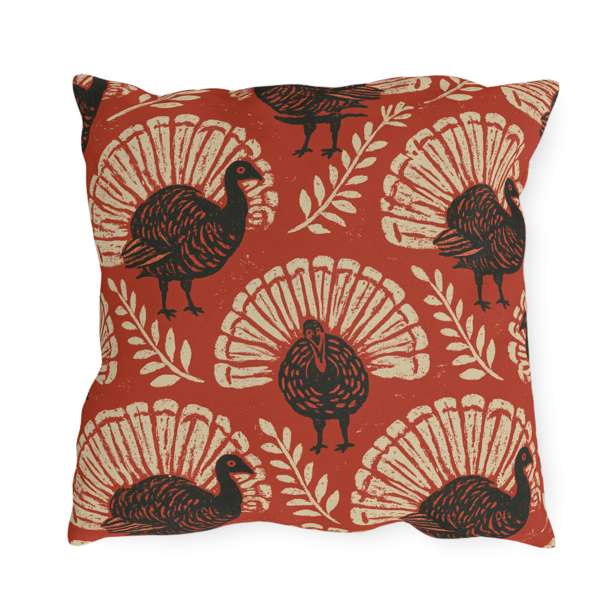 Block print turkeys and cream leaf sprigs on a brick red outdoor pillow