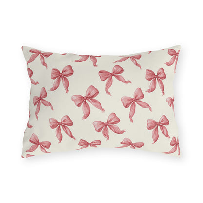 Rose pink engraved ribbon bows scattered on cream outdoor lumbar pillow