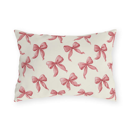 Rose pink engraved ribbon bows scattered on cream outdoor lumbar pillow