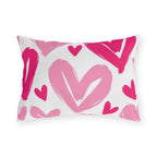 Hot pink outdoor lumbar pillow with large painted hearts in hot pink and soft pink on white