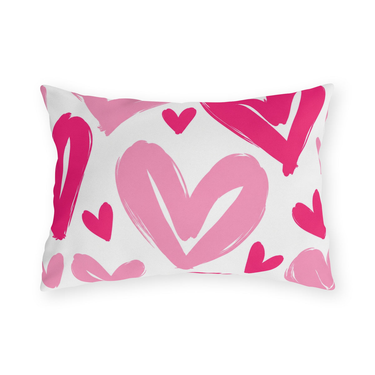 Hot pink outdoor lumbar pillow with large painted hearts in hot pink and soft pink on white