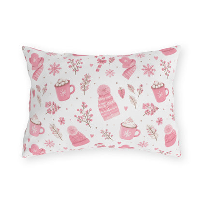 Pink beanies, mittens, cocoa mugs and snowflakes on white outdoor lumbar pillow