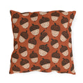 Block-printed cream and dark brown acorns on rust orange outdoor pillow