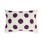 Aubergine polka dot outdoor lumbar pillow with large deep purple dots on cream