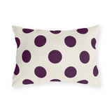 Aubergine polka dot outdoor lumbar pillow with large deep purple dots on cream