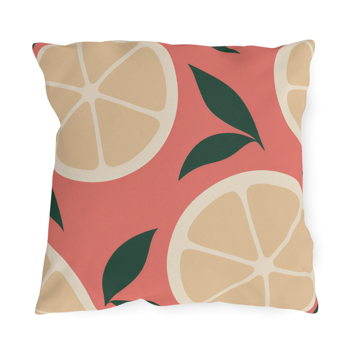Modern outdoor pillow with oversized cream citrus slices and dark green leaves on coral pink