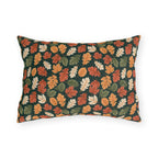 Rust, orange and cream autumn leaves on forest green outdoor lumbar pillow