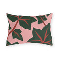 Modern outdoor lumbar pillow with dark green ivy leaves and red veins on blush pink