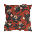 Navy sea holly thistles with cream heads on a brick red outdoor pillow