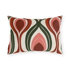 Modern retro outdoor lumbar pillow with seventies ogee waves in rust, coral pink and forest green on cream