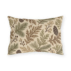 Cedar, spruce and pinecones in sage and brown on a cream outdoor lumbar pillow