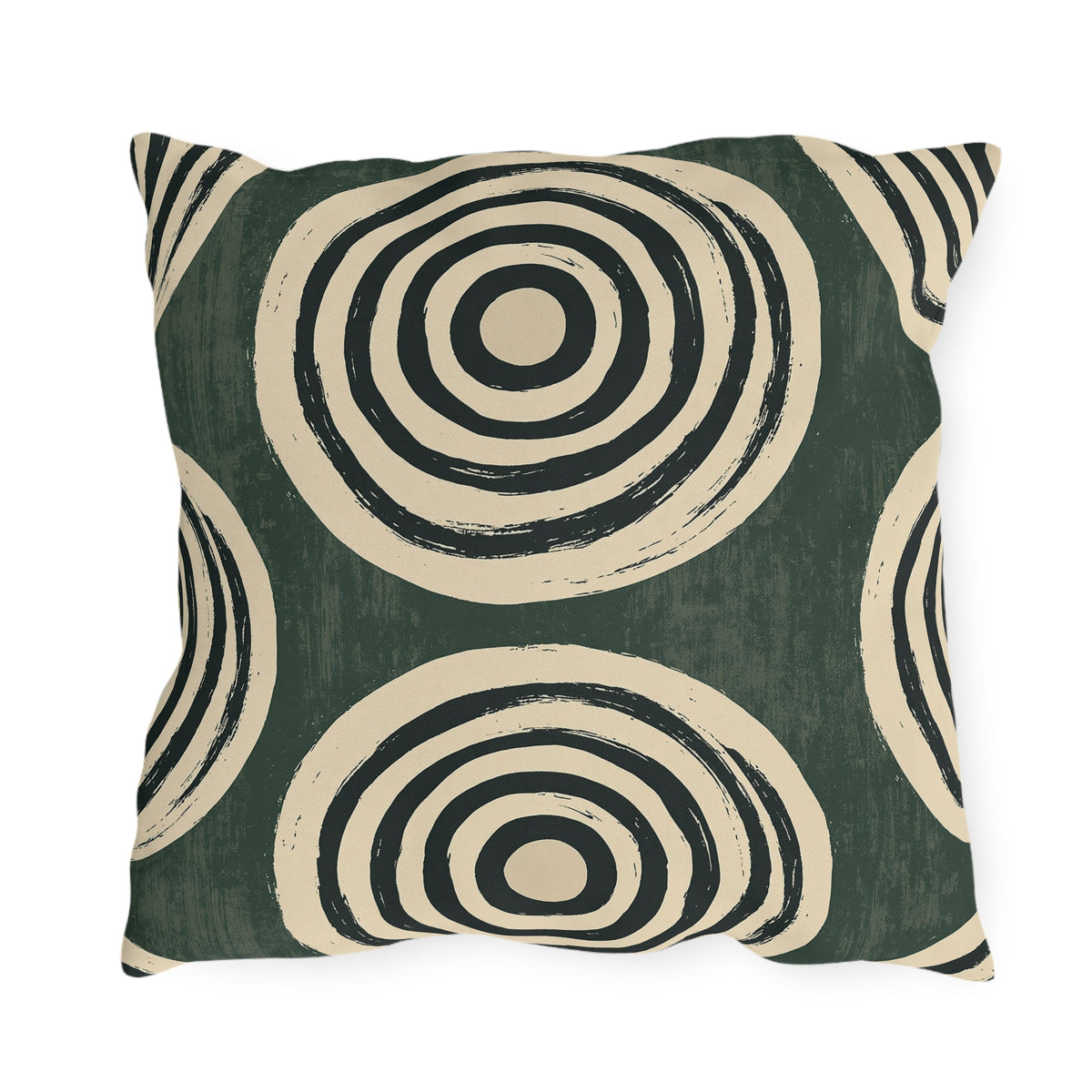 Black and cream concentric rings on a mottled forest green outdoor pillow