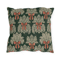 Cream foliage sprays tied with clay bows on a deep forest green outdoor pillow