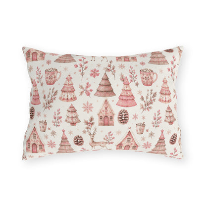Pink patterned Christmas trees, deer, gingerbread houses and cocoa mugs on cream outdoor lumbar pillow