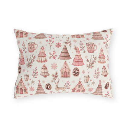Pink patterned Christmas trees, deer, gingerbread houses and cocoa mugs on cream outdoor lumbar pillow