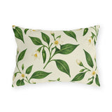 White pepper blossoms, green leaves and small chilies on a cream outdoor lumbar pillow