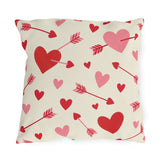 Valentine's outdoor pillow with red and pink cupid arrows and hearts on cream