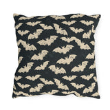 Bone white bats on a charcoal outdoor pillow, worn block print Halloween pattern