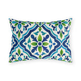 Blue and green Moroccan tile pattern on a white outdoor lumbar pillow