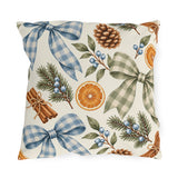 Christmas outdoor pillow with watercolor blue and sage gingham bows, dried orange slices, cinnamon sticks, pinecones and pine on cream