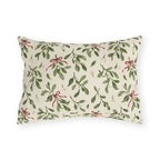 Christmas mistletoe outdoor lumbar pillow with sage green sprigs, white berries and thin red bows on warm cream