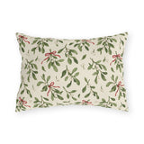 Christmas mistletoe outdoor lumbar pillow with sage green sprigs, white berries and thin red bows on warm cream