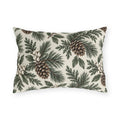 Pine branches, cedar sprigs, pinecones and white berries on a cream outdoor lumbar pillow