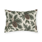 Pine branches, cedar sprigs, pinecones and white berries on a cream outdoor lumbar pillow
