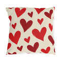 Valentine's outdoor pillow with hand-painted red hearts tossed across cream