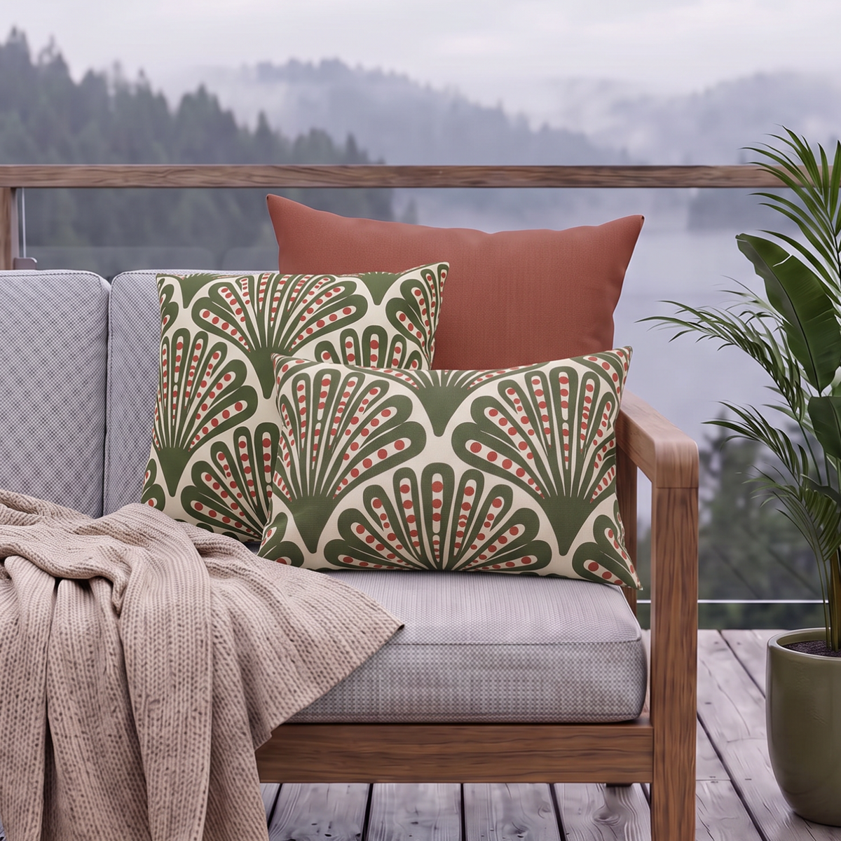Green and red dotted fan outdoor pillow and outdoor lumbar pillow styled together as a set