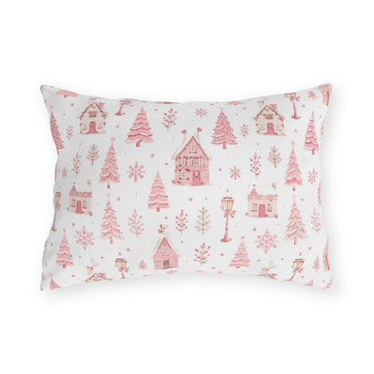 Pink gingerbread houses, trees and lampposts on white outdoor lumbar pillow